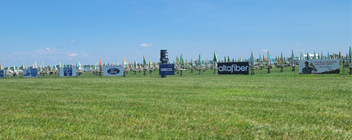 Sponsor-and-advertising-2 Images of sponsor banners in the distance on a fence. They are approximately two to eight feet wide and 2 feet tall. Various colors.