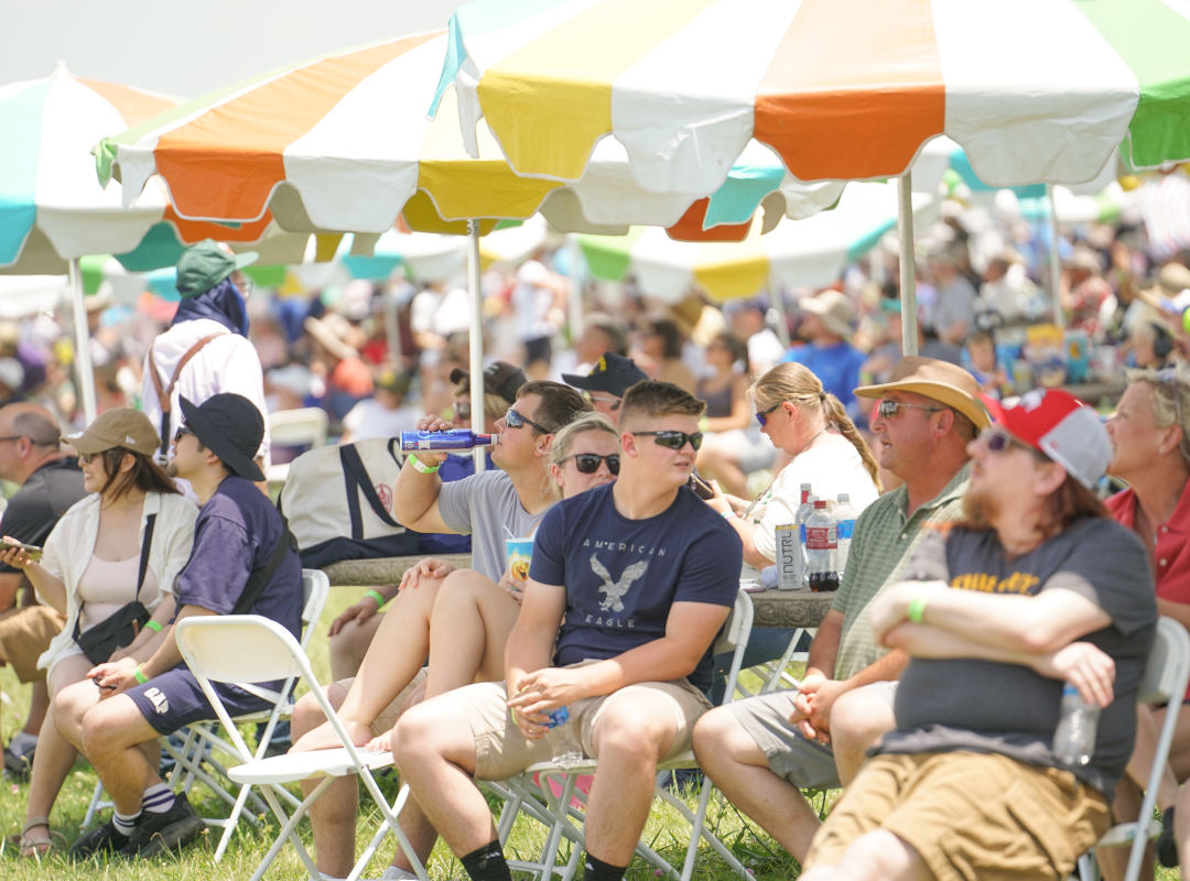 Pavilion Seating Pavilion Seating at the Dayton Air Show provides shaded comfort under colorful umbrellas where guests relax in folding chairs and enjoy refreshments while watching aerial performances. The section offers a lively, social atmosphere with clear runway views, combining convenience, shade, and an enjoyable vantage point for aviation enthusiasts.
