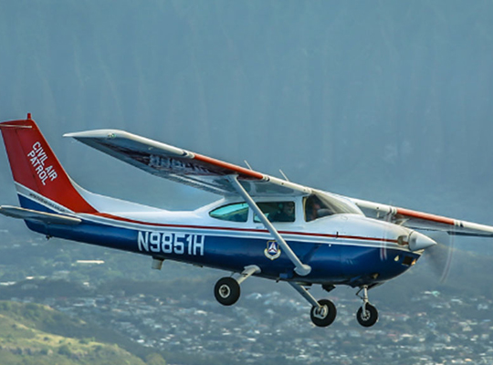 Cessna 182 civil patrol aircraft in flight over landscape