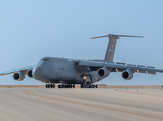 USAF C-5M Super Galaxy on runway viewed from front with landing gear down