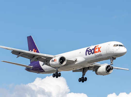 FedEx Boeing 757 cargo aircraft in flight with landing gear extended