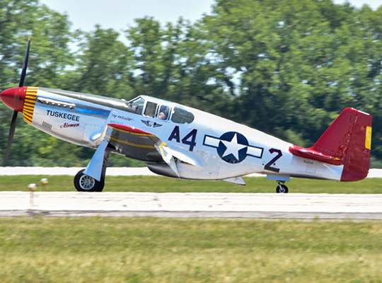 P-51D Mustang “By Request” taxiing on runway with Tuskegee Airmen markings