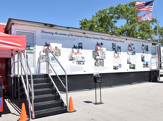 CAF Rise Above educational trailer with graphics and stairs for entry