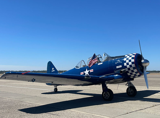 T-6 Texan aircraft parked on ramp with blue paint scheme