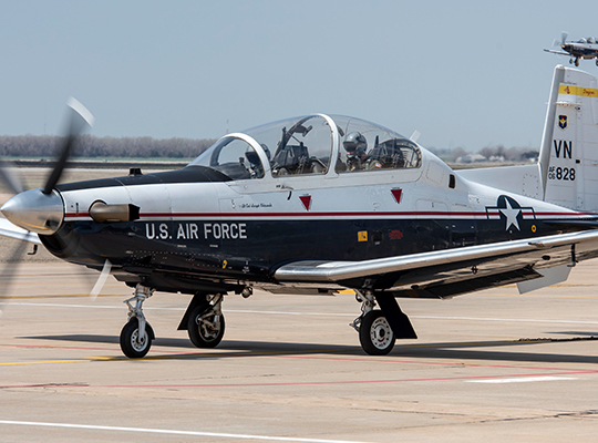 USAF T-6 Texan II training aircraft taxiing on runway